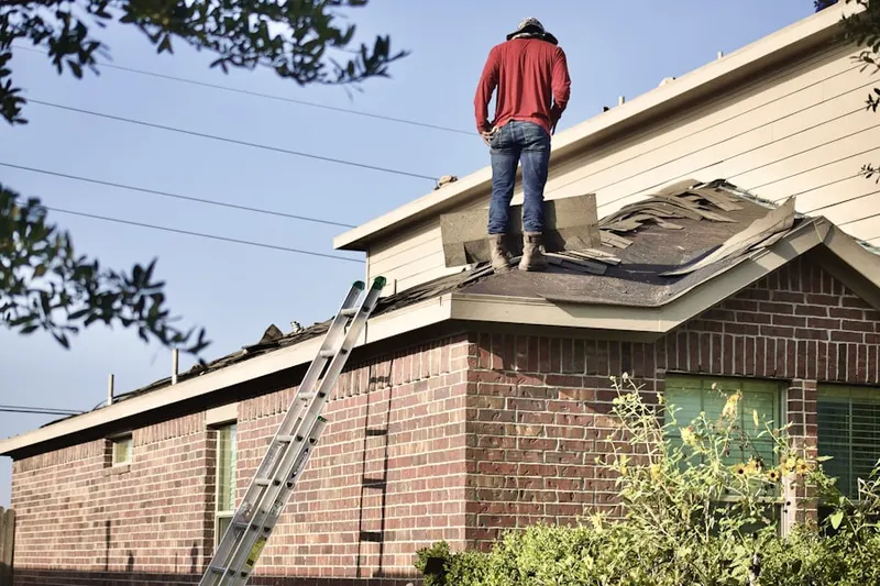 Professional roofer working on a residential roof in Peachtree Heights West
